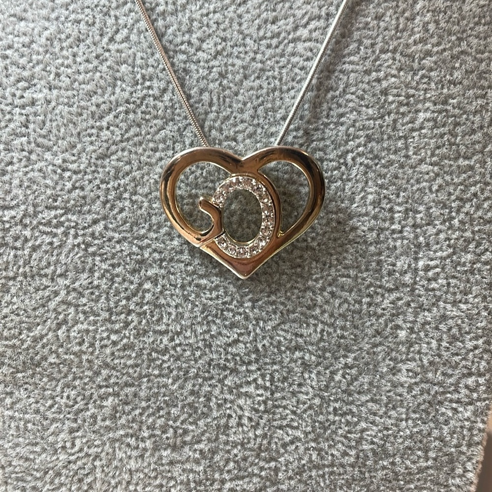 Heart necklace in silver tone and  gold tone, adorned with sparkly rhinestones.